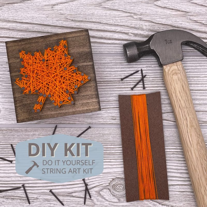 selection of nails, wooden boards, and colorful threads for string art