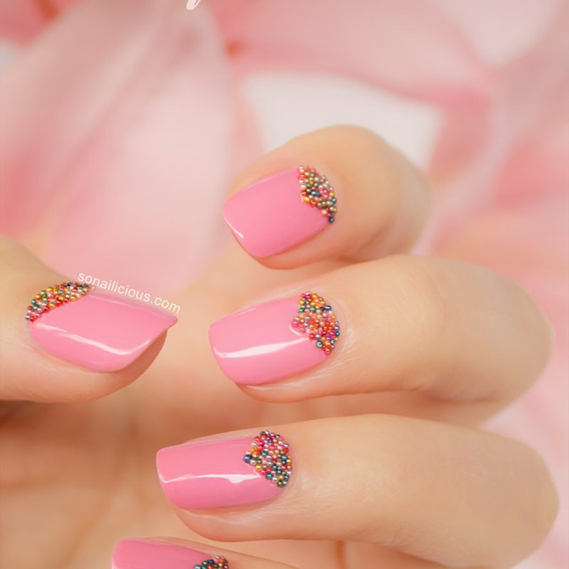 stylish manicure featuring nail art with caviar beads in pastel tones