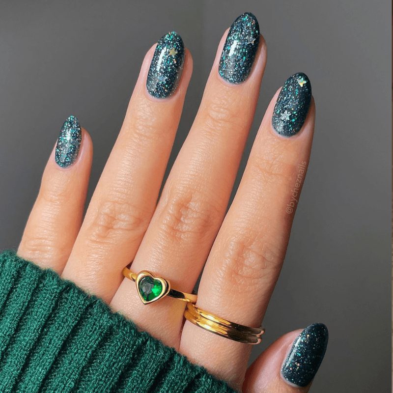 variety of holiday nail art glitter colors in jars and on nails