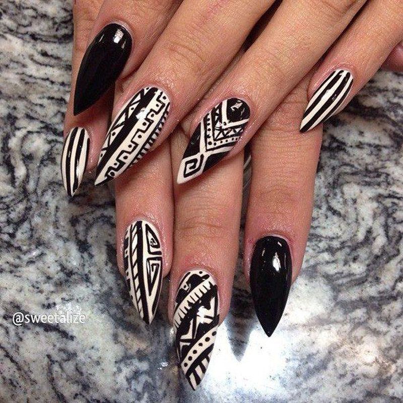 various simple tribal nail art patterns featuring stripes and triangles