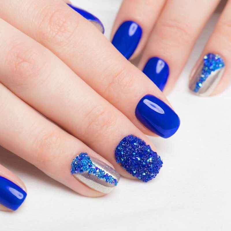well-maintained rhinestone nails with shiny finish and smooth topcoat