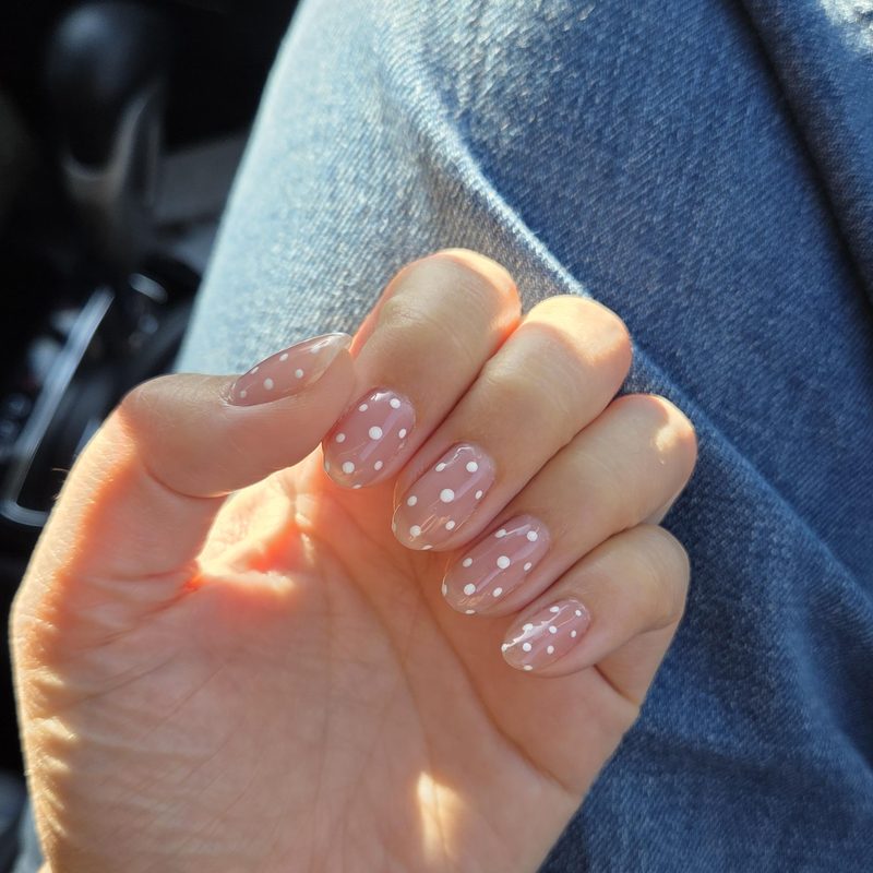 woman painting her nails with nail polish at home for DIY nail art